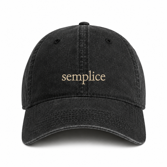 A black washed baseball cap with the word 'semplice' embroidered in a light beige serif font on the front, shown against a plain white background.